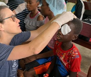 A Samaritan's Purse nurse removes bandages from the eyes of a young boy after he received cataract surgery at ELWA hospital in Monrovia, Liberia, the summer of 2023.