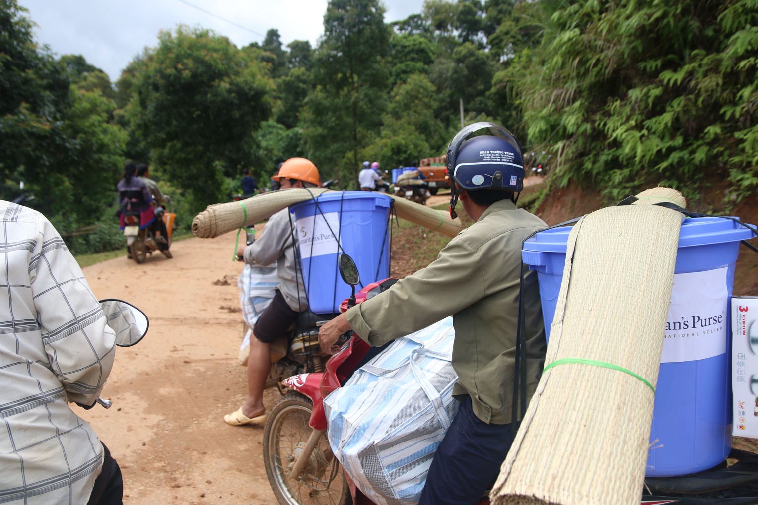 Relief supplies are delivered by motorbike to homes in the region.