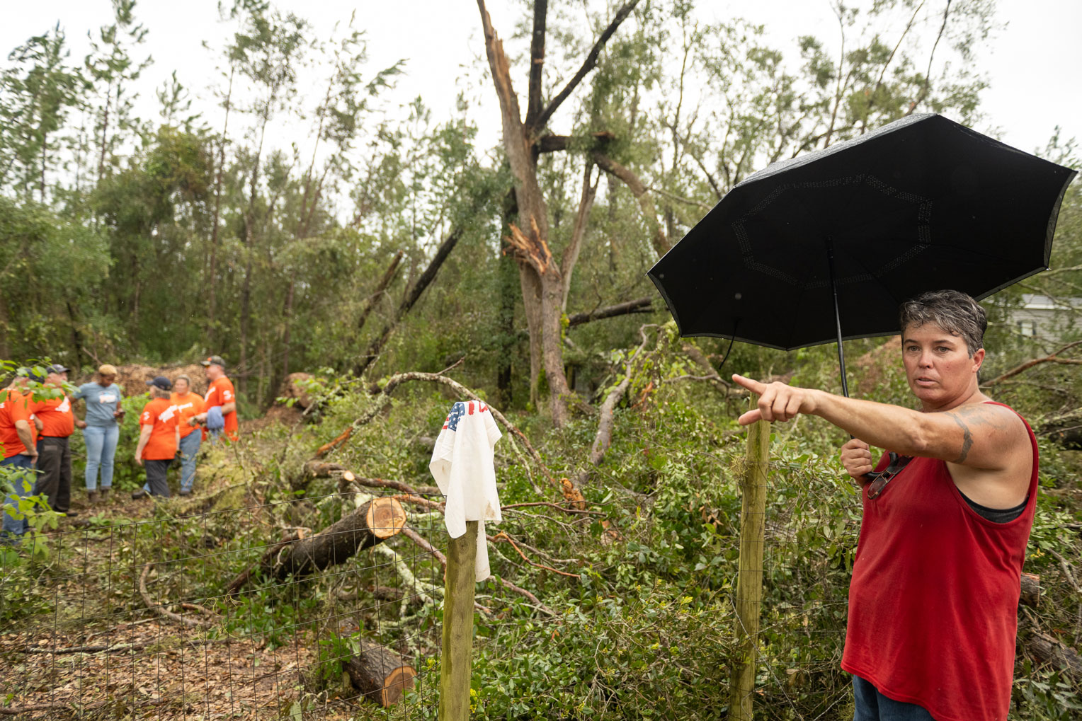 Kim Cannon describes the monstrous tangle of trees and debris entrapping her brother, Kevin, in his Perry, Florida, home.
