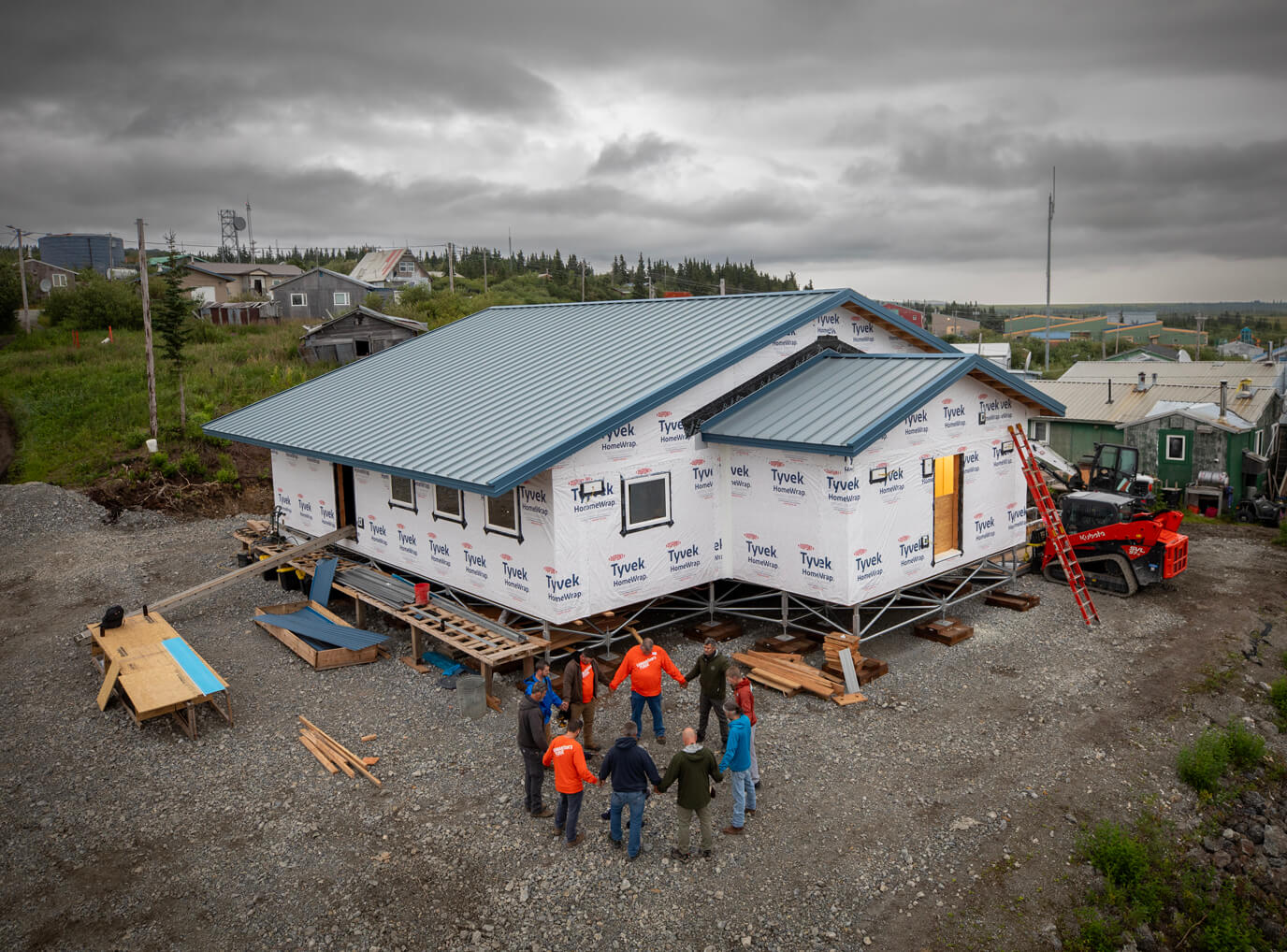 Samaritan's Purse staff and volunteers pray as they begin work one morning on the new church building in Koyuk, Alaska.