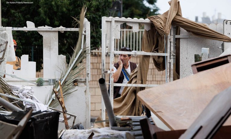 A man looks aghast at the ruins of a home attacked in Ashkelon, Israel, on Oct. 7.