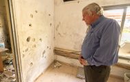 Franklin Graham looks at bullet holes in Israel
