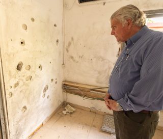 Franklin Graham looks at bullet holes in Israel