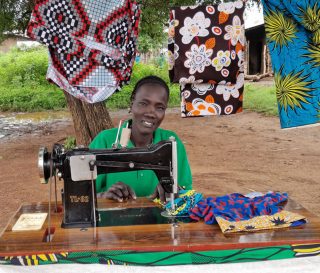 Trained in our tailoring program in Maiwut, Buk uses her new-found trade to support her family.