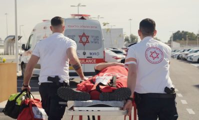 Two Israeli medics guide a gurney toward one of the new ambulances provided by Samaritan’s Purse in Jerusalem.