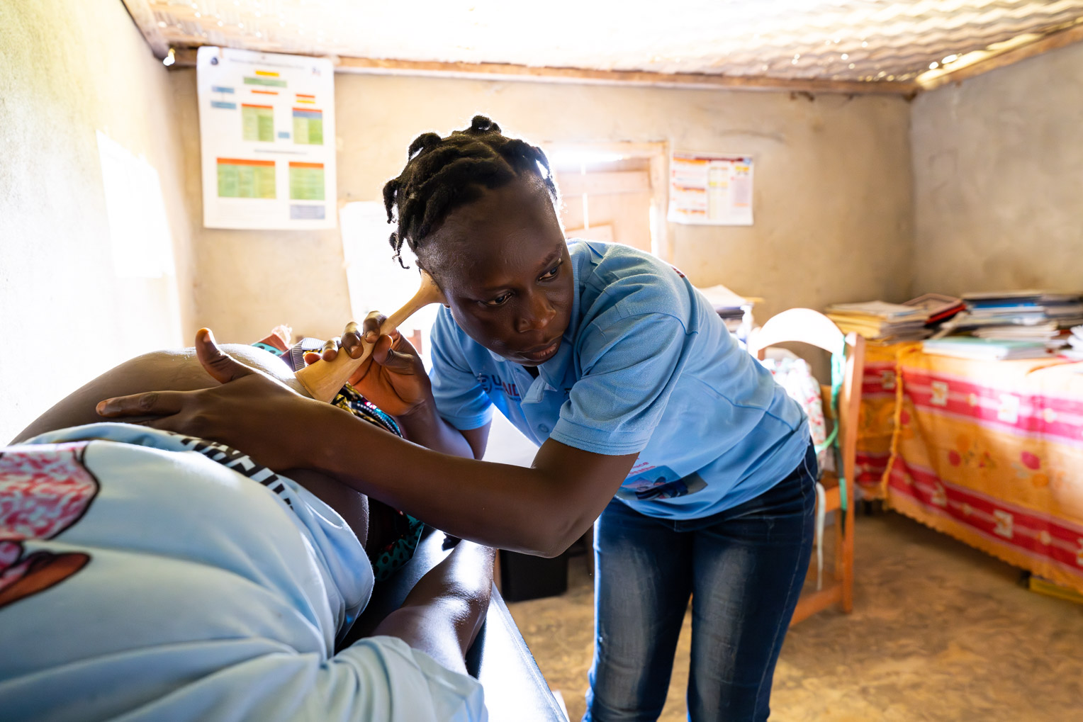 A nurse uses a listening tool to monitor a baby's health at a local clinic recently renovated by Samaritan's Purse with a maternity ward.