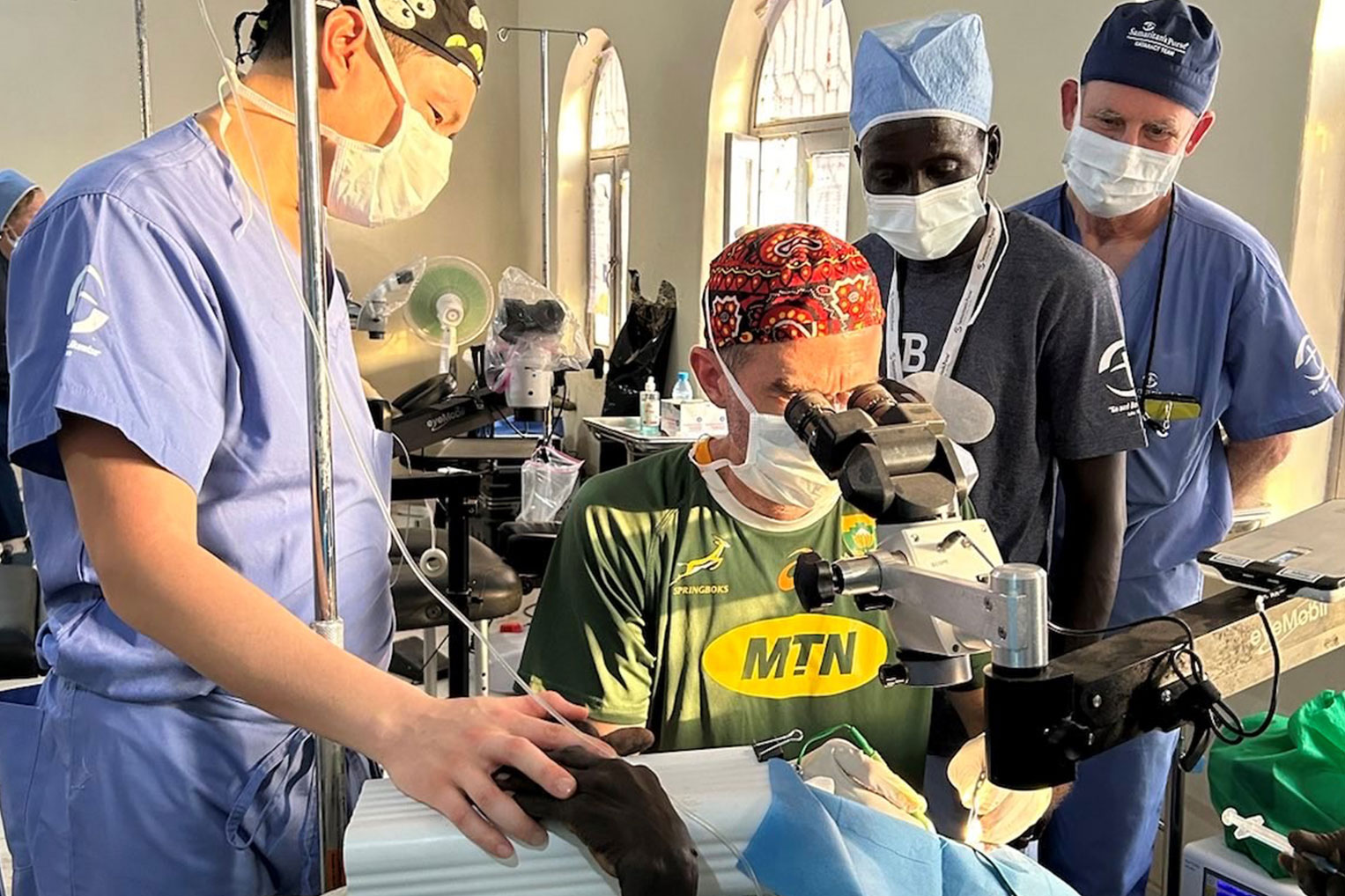 The surgical staff use high-powered optics to remove cataracts.