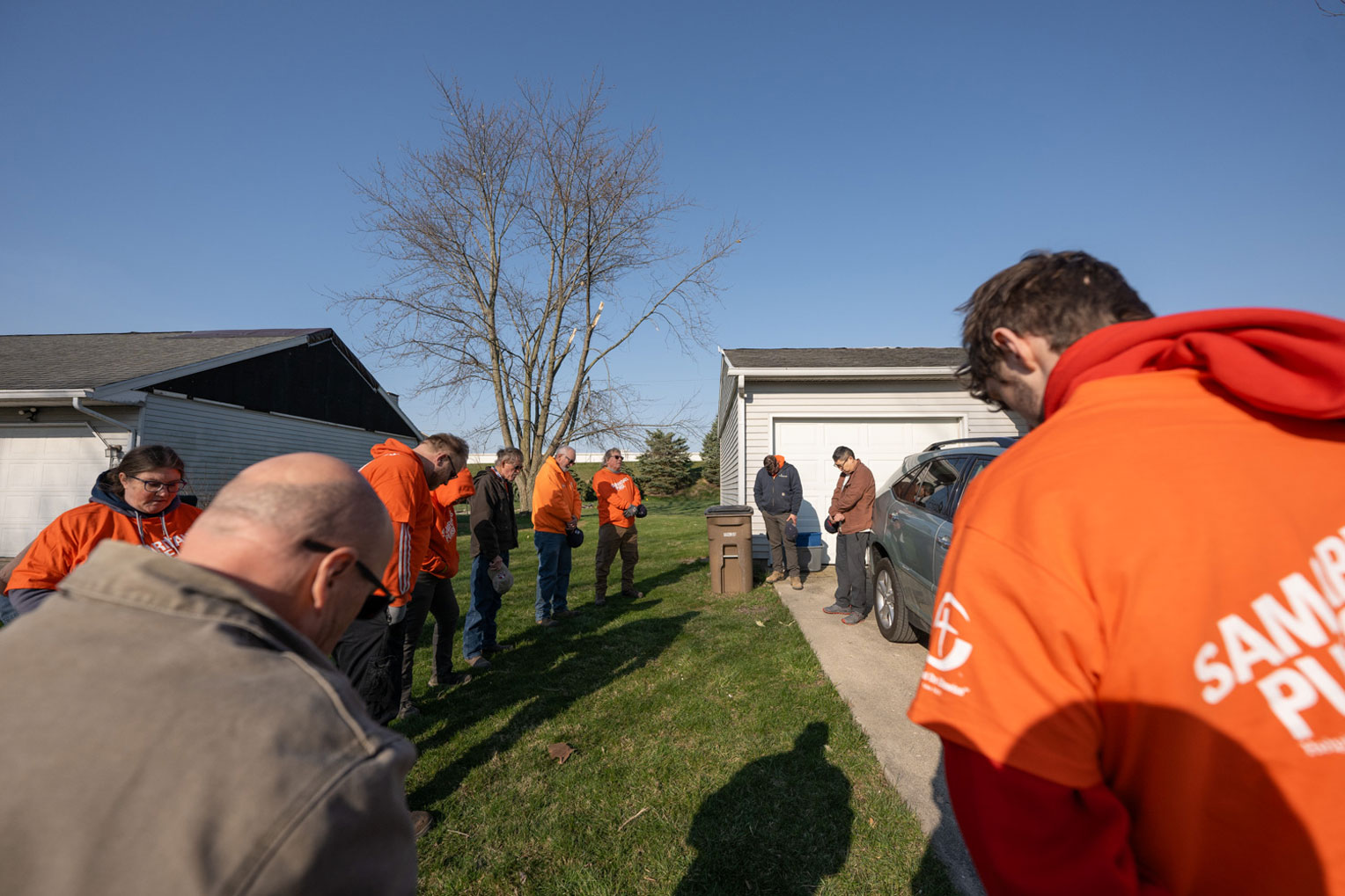 Volunteers pray with a homeowner in Winchester, Indiana.
