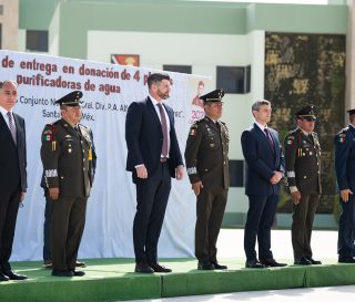 Edward Graham, chief operating officer, and Dave Philips, deputy director of international projects, stand with Mexican leaders at the recent handover ceremony.