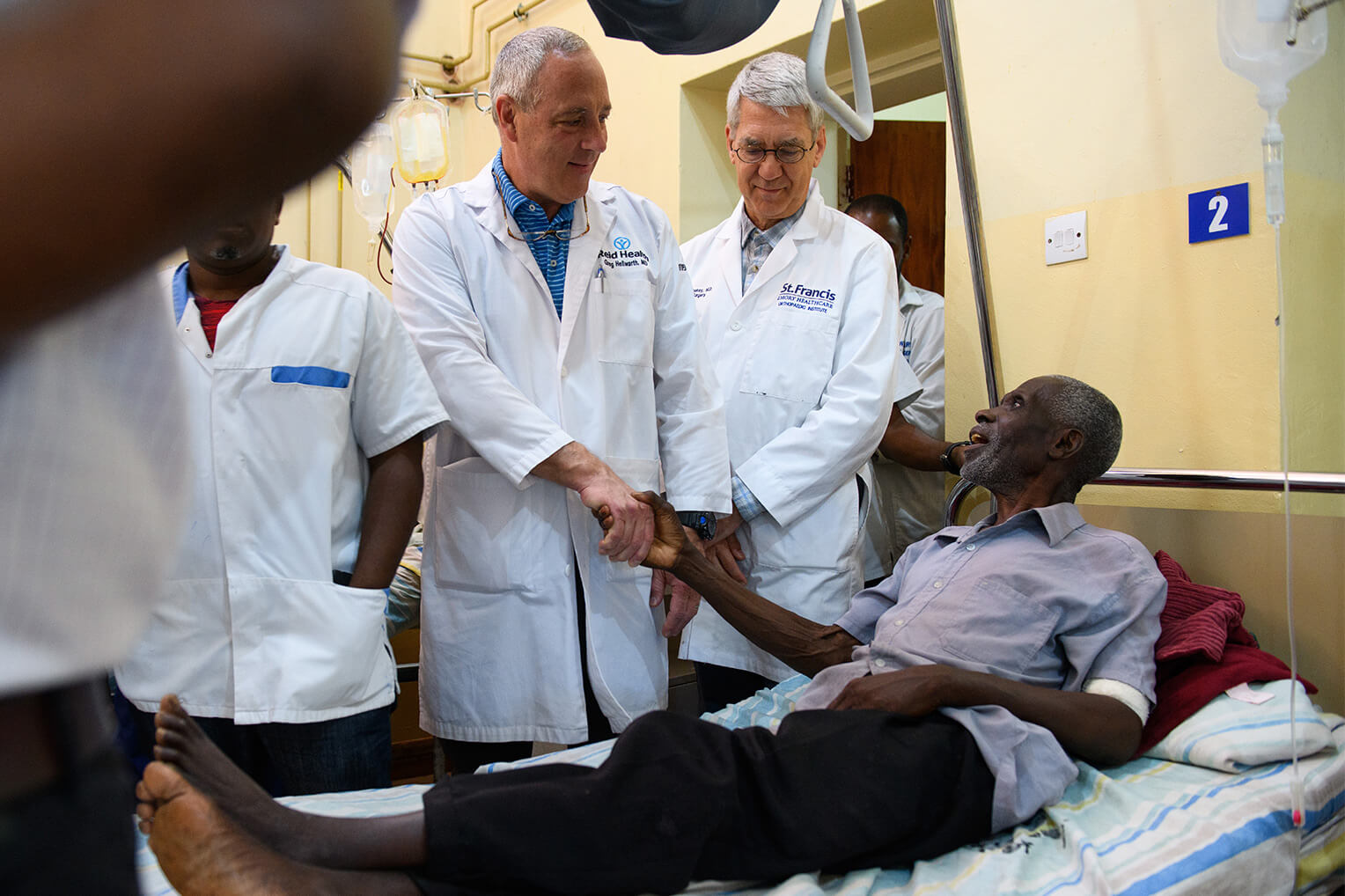 Drs Hellwarth, left, and McCluskey, right, visit Jephither following his successful surgery.