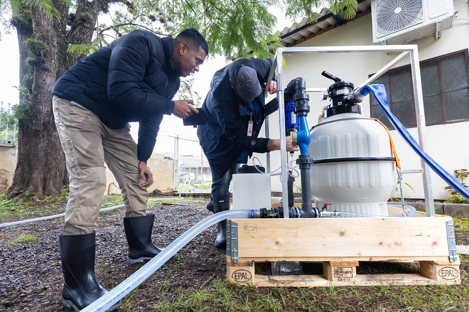 Samaritan's Purse staff members install a community water filtration system. A majority of the population in the region still have no access to clean water.
