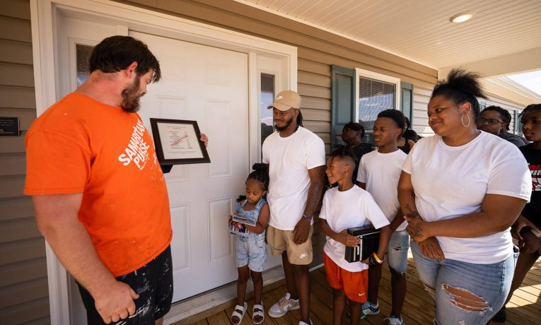 Josh, Brenna, and their three children were joined by family, friends, and Samaritan's Purse volunteers and staff in an exuberant dedication before moving into their new home May 30.
