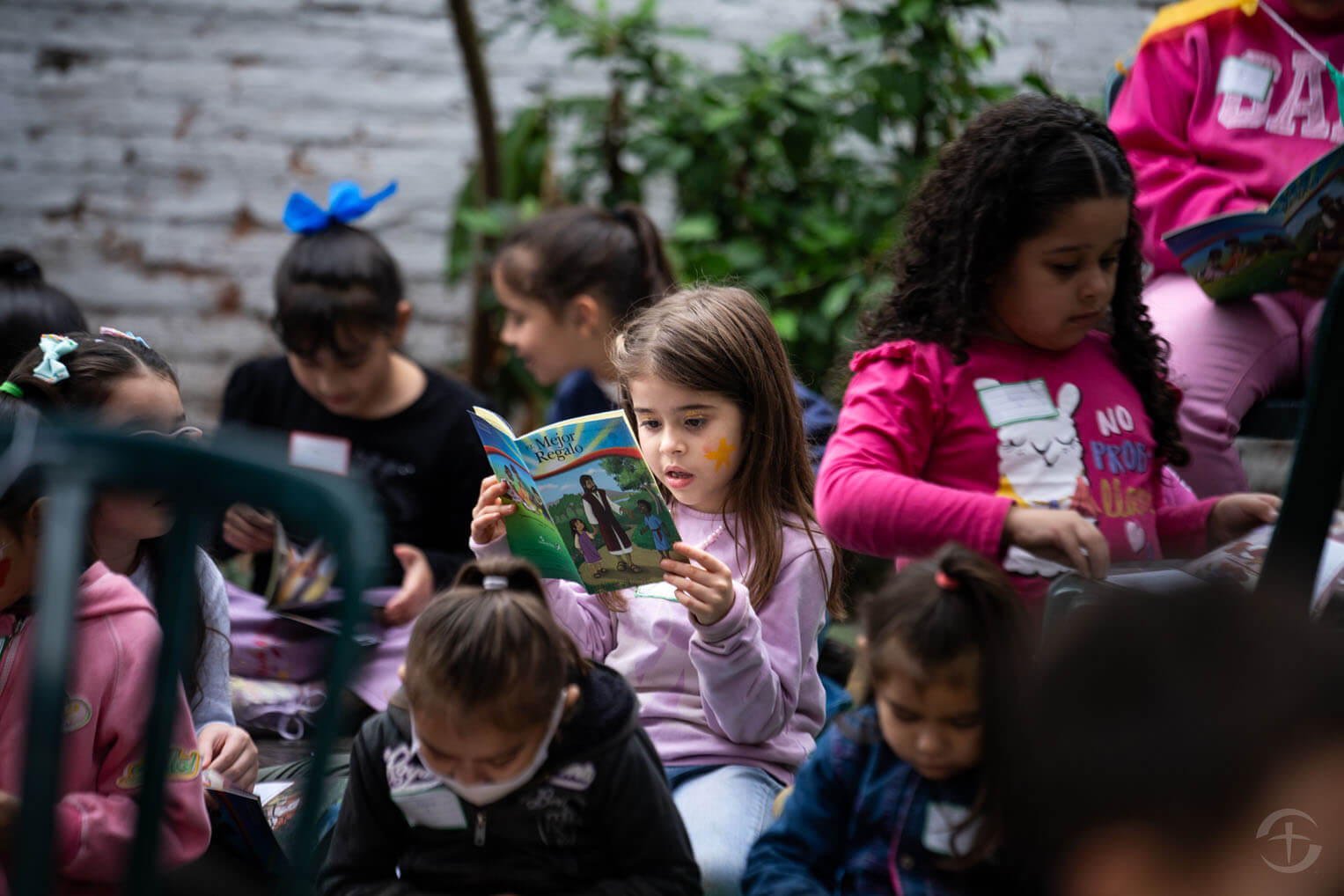 A little girl diligently reads The Greatest Gift booklet that explains the Gospel clearly for children to understand.