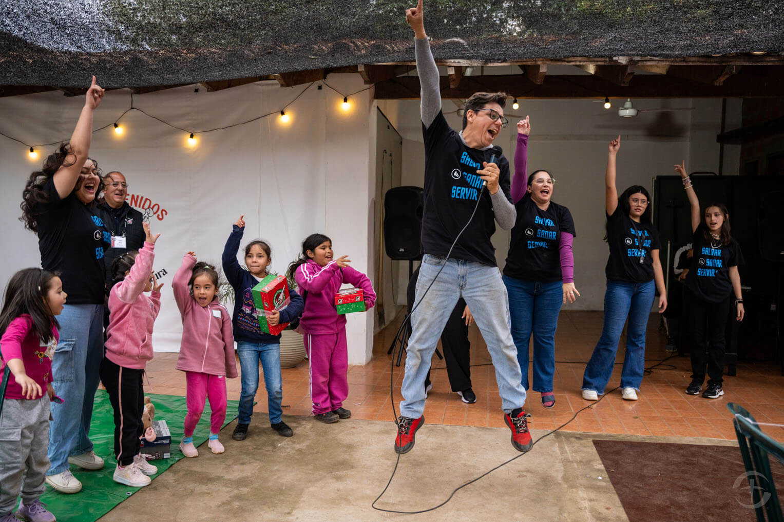 Pastor Roger jumps with joy as he and his team say "Amen"--pointing a finger in the air for the first half of the word and bringing it down to finish it.