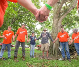 Samaritan's Purse volunteers gather around Tim and Leslie Burch to pray for them and tell them that they are not forgotten by God.