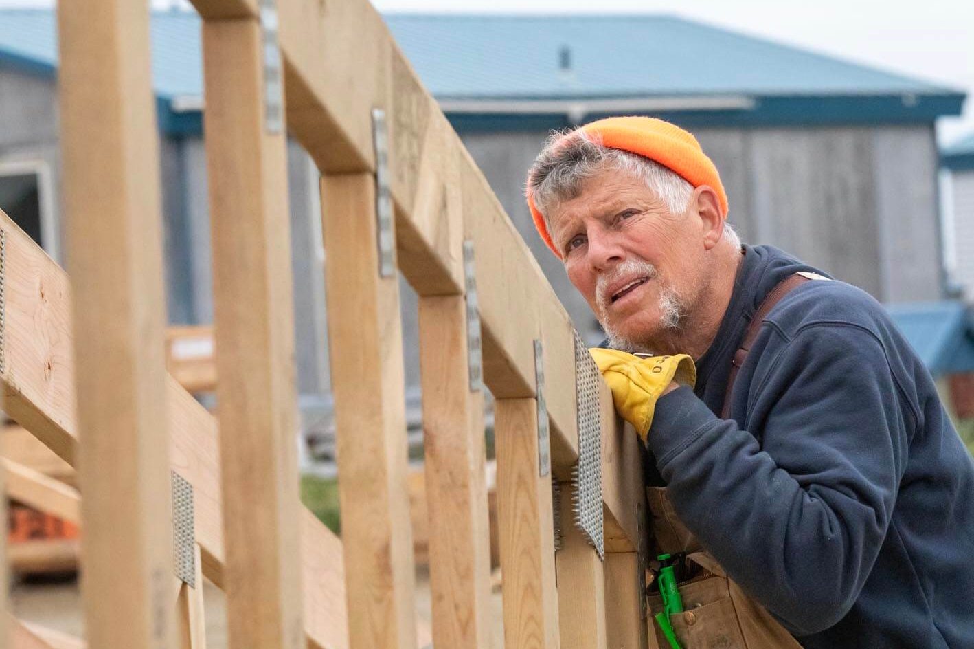 Dana Woodward of Belt, Montana, checks on a truss for the new church building.