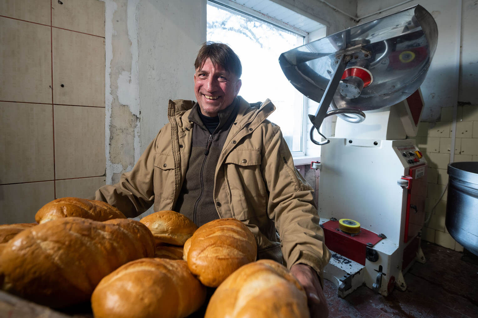 Sergey stands with a new batch of bread made from equipment provided by Samaritan's Purse. 