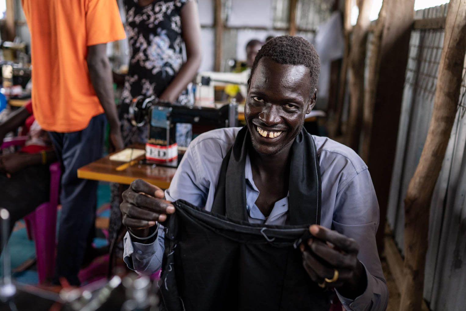 Through our tailoring class, displaced men and women are learning to sew and to smile again.