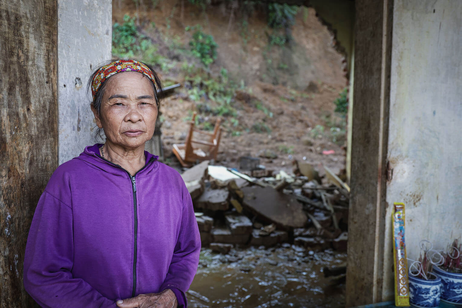 Tran stands in front of her crumbled home--one among the estimated 235,000 homes destroyed by Typhoon Yagi in Vietnam.