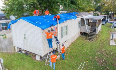 Volunteers help patch Rebecca Clement’s roof in Houma, Louisiana, after Hurricane Francine.