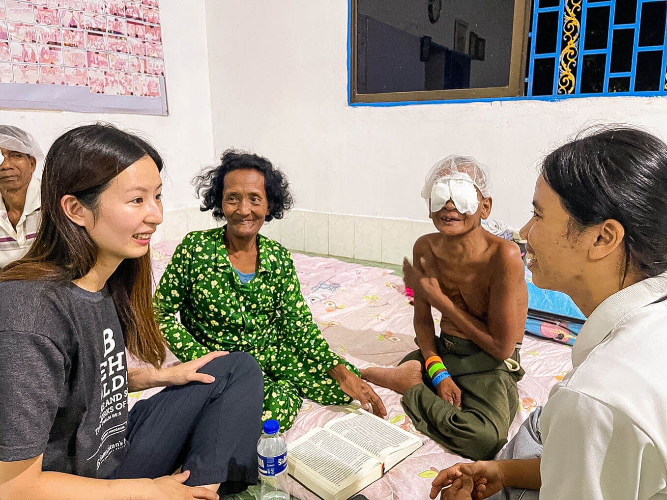 Sao and Mao listened as local Samaritan's Purse staff shared their testimonies at the church. Although he couldn't see, Sao's heart began to soften to the Gospel.