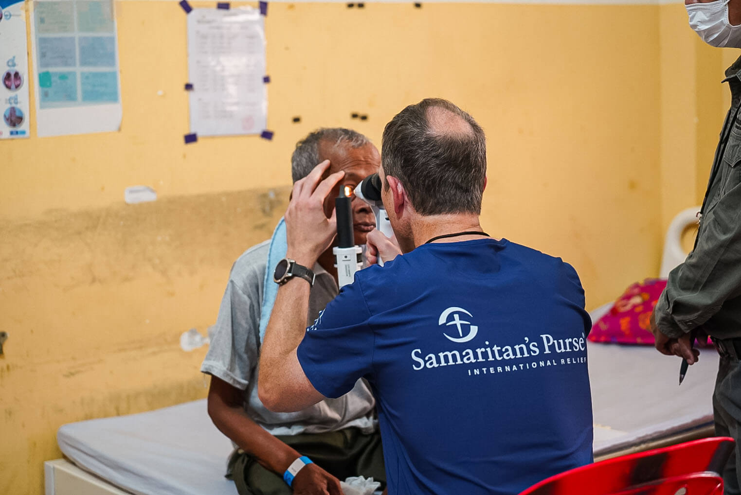 A Samaritan's Purse doctor inspects Sao's before his surgery.