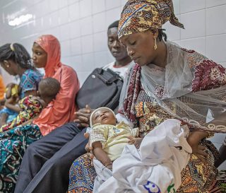 Mission hospital in Togo, woman holding child