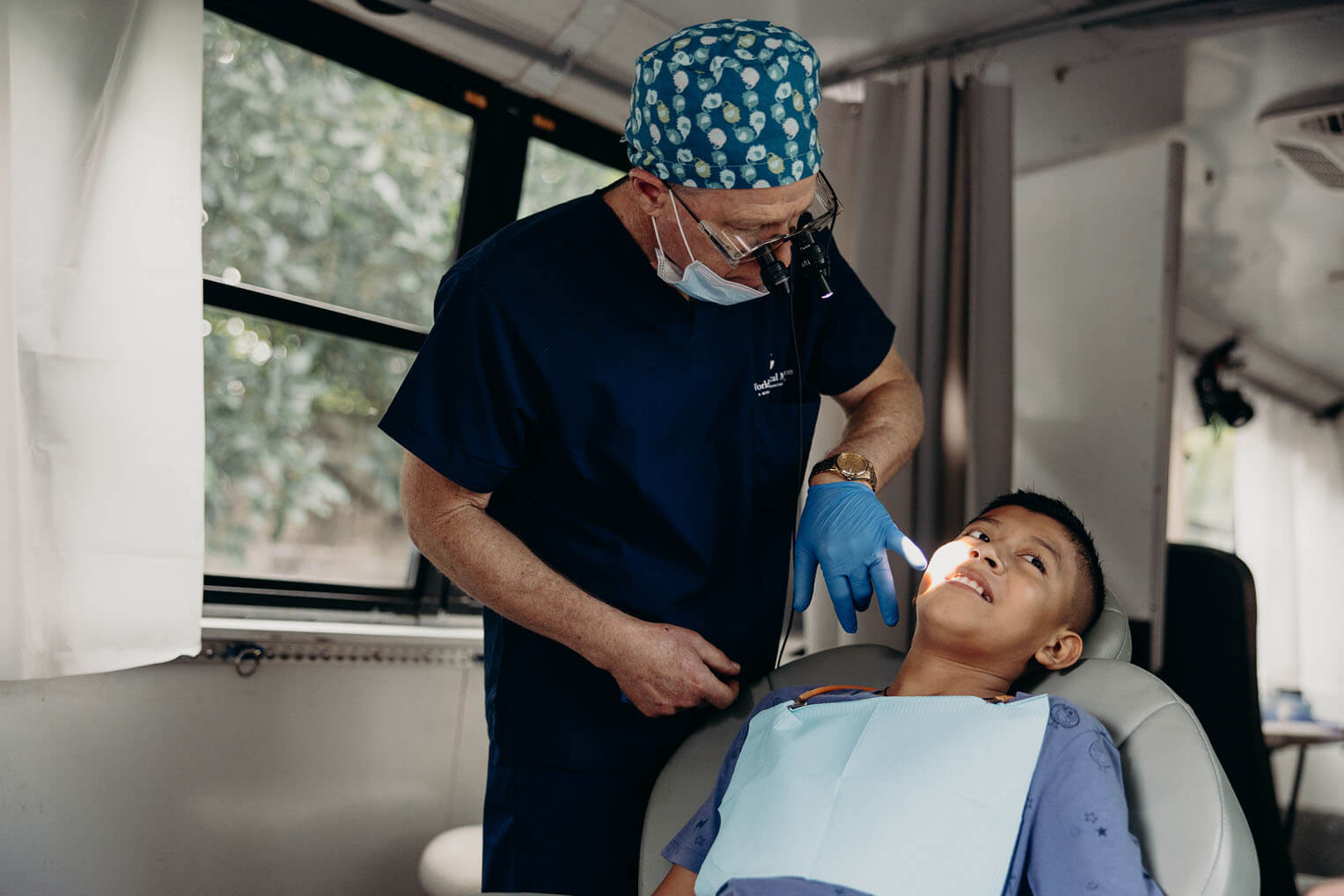 Dr. Zoch provides fillings and extractions aboard the mobile clinic bus with the same quality of those he completes in the United States.