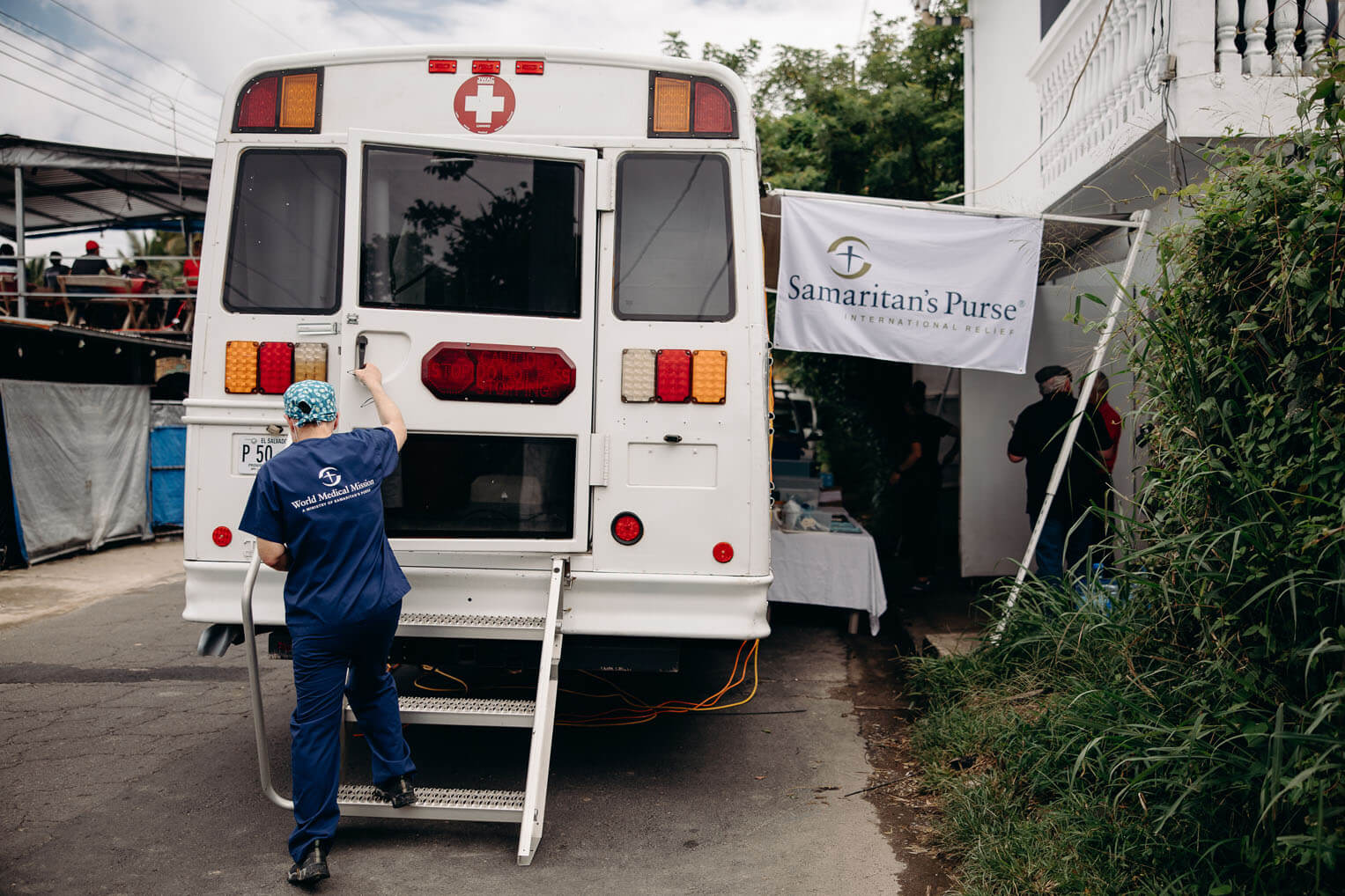 Dr. Fred Zoch gathers the supplies he needs and heads into the dental bus to care for a patient.