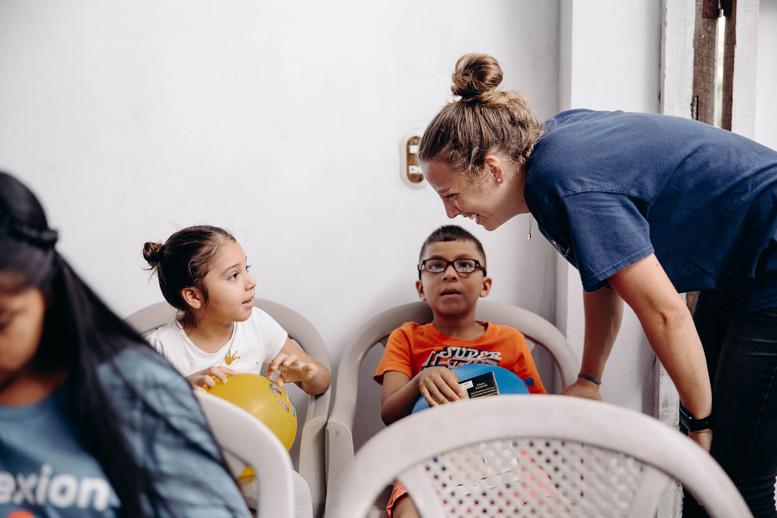 Madison Strausbaugh, the World Medical Mission specialty teams program manager, brings joy to children waiting to receive dental care from our team. 