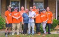 Volunteers presented Valdosta homeowners Scott and Terri a special Billy Graham Study Bible after completing work on the couple's tree-damaged home and property.