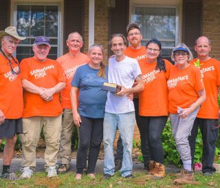 Volunteers presented Valdosta homeowners Scott and Terri a special Billy Graham Study Bible after completing work on the couple's tree-damaged home and property.