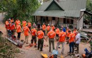 Samaritan's Purse volunteers gather to pray after working at a home in Buncombe County.