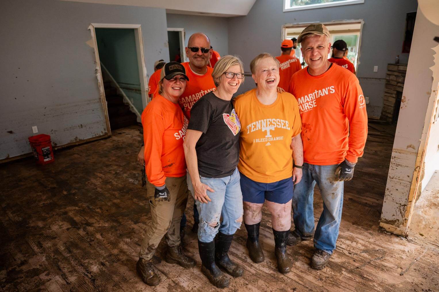 Julia, center, in the Tennessee shirt, was grateful for Samaritan's Purse volunteers who helped her work on her flooded home.