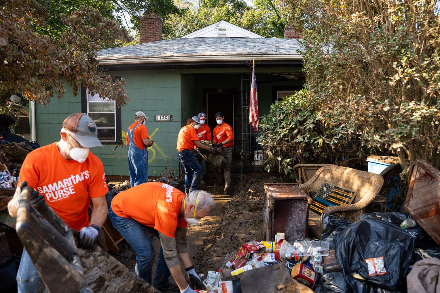 Volunteers carefully remove belongings from the Dixons home. The couple have lived in this house since they moved to Swannanoa shortly after their marriage over 30 years ago.