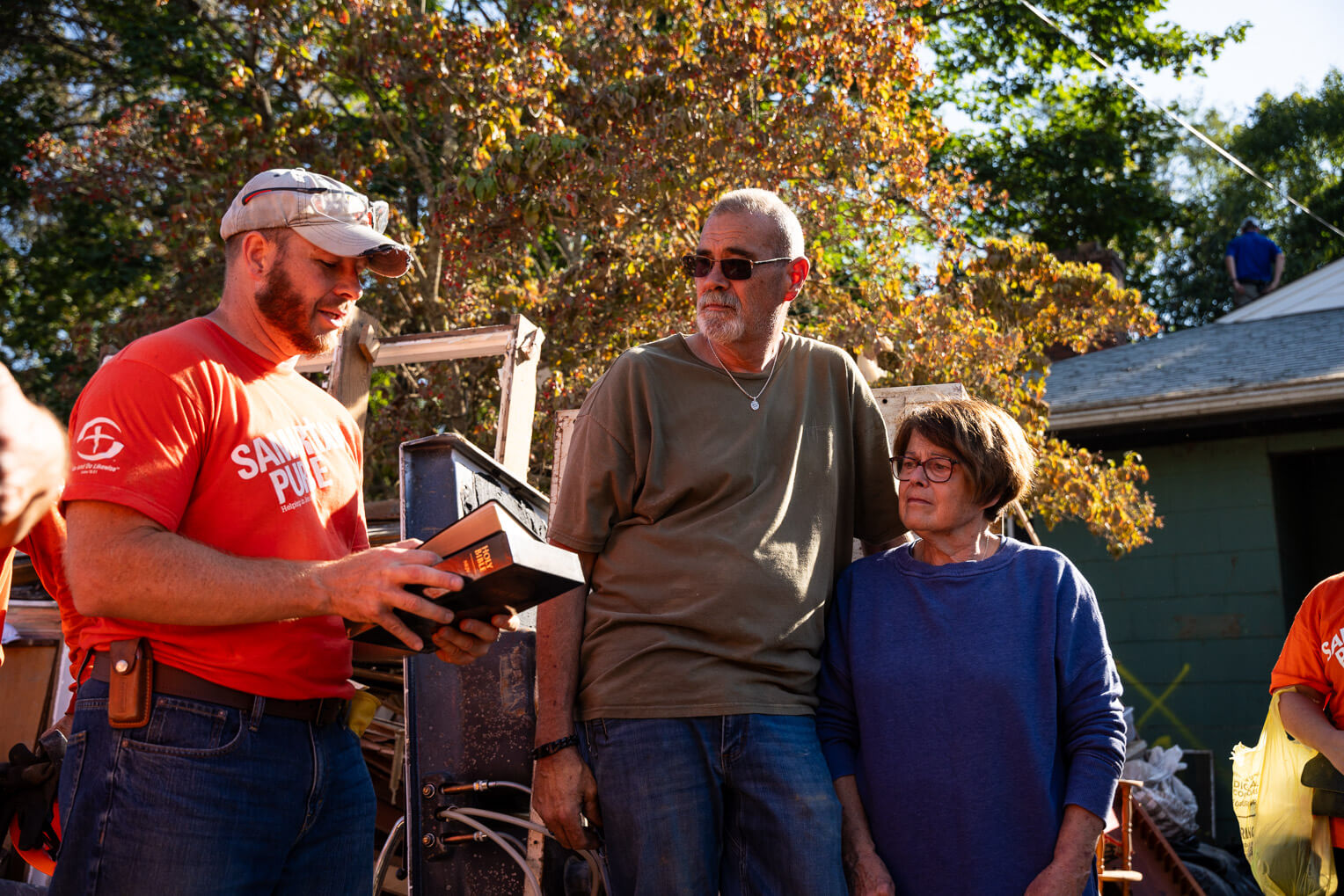 Samaritan's Purse volunteers gathered around the Dixons after work on their home was finished, providing prayer and encouragement for the long road to recovery ahead. 