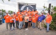 Volunteers gather with homeowners Dale and Tracey Wallace after completing work on their Madeira Beach, Florida home.