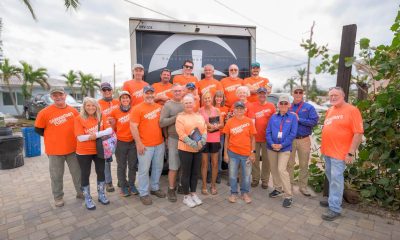 Volunteers gather with homeowners Dale and Tracey Wallace after completing work on their Madeira Beach, Florida home.