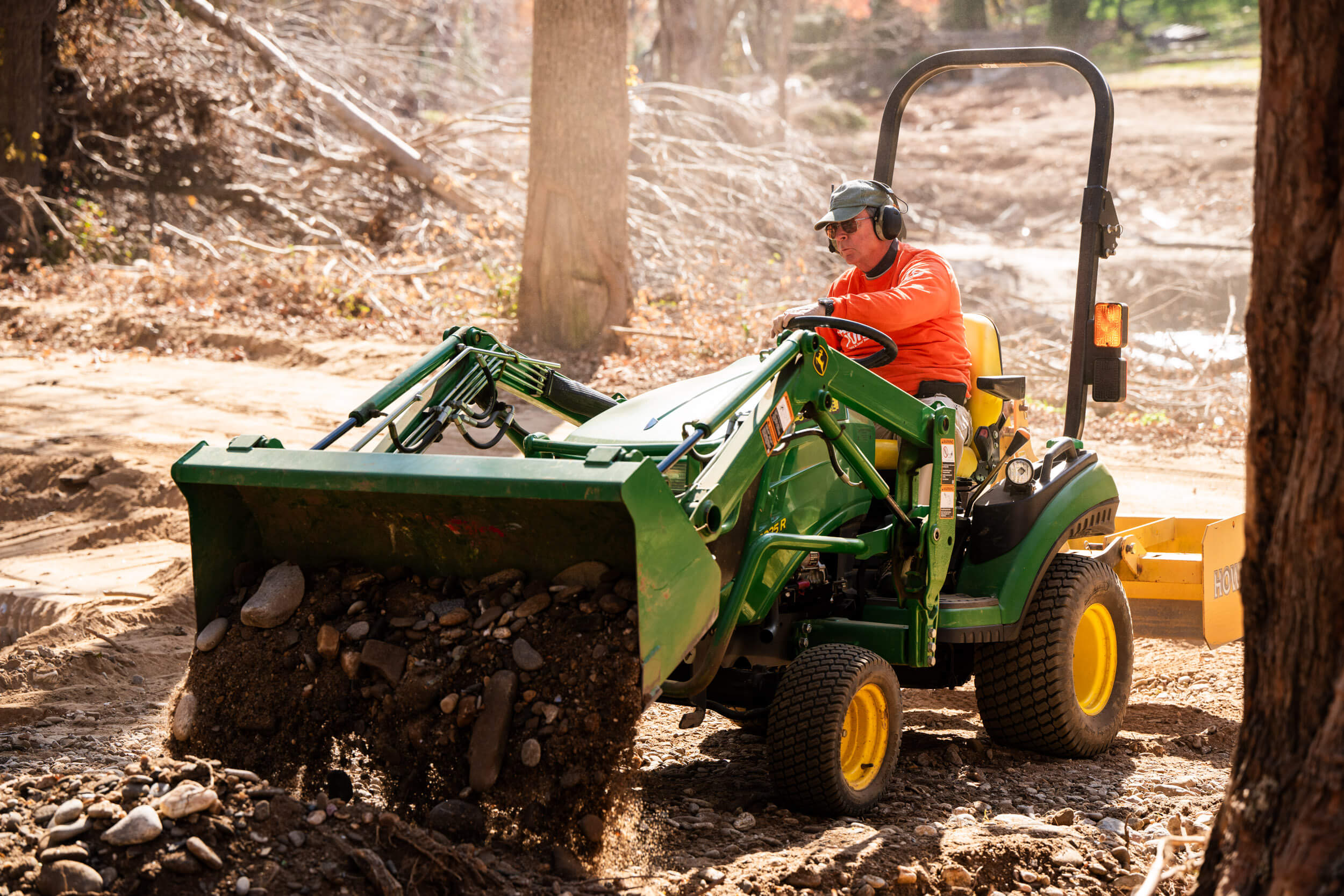 Volunteers operated an excavator to clear debris from the yard.