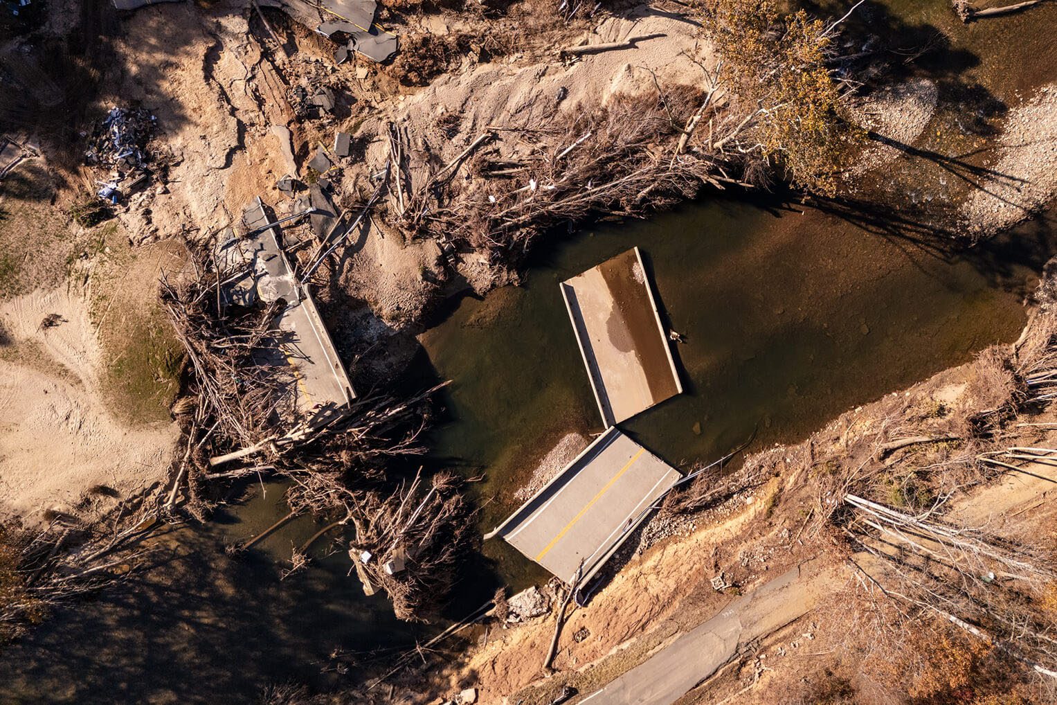 The bridge near their home was destroyed by the force of water and debris.