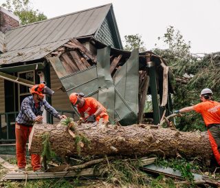 Volunteers are cutting up trees in Buncombe County, which was devastated by Hurricane Helene.