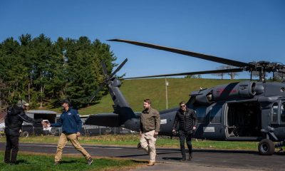 Edward Graham (right) and Donald Trump Jr (next to far left) flew over devastated areas of North Carolina.