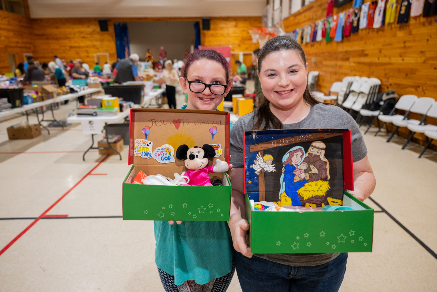 Volunteers show off creative shoeboxes that will soon travel to faraway places.