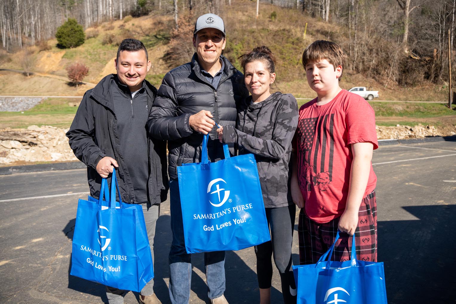 Samaritan's Purse staffer Aaron Ashoff gathers with a family after they receive a meal.