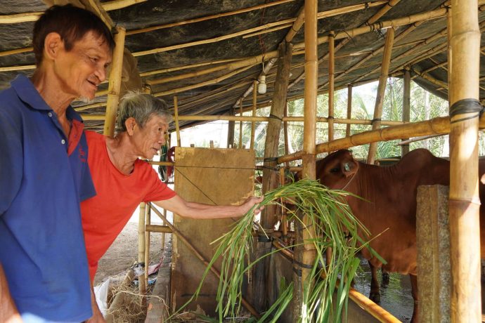 Sau (red shirt) has found an unexpected blessing from the Samaritan's Purse livelihood program: fellowship with his community. 