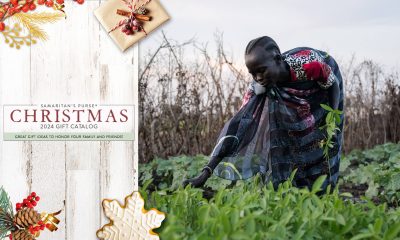 A woman pulls plants from the garden near her home near the river in Mayom County South Sudan.