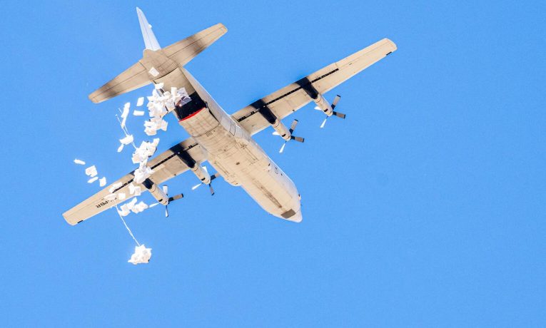 Food airdrops from a cargo plane provide lifesaving relief to areas without road access.