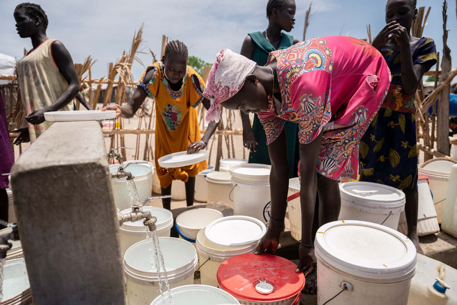 Nya joins others in the queue at the local water point. Samaritan's Purse has established several such water points in the community.