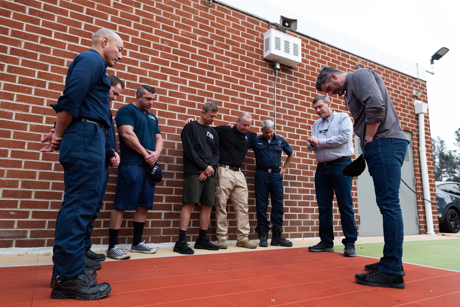 Graham and Luther Harrison, vice president of North American Ministries at Samaritan's Purse, gathered with firefighters for prayer.