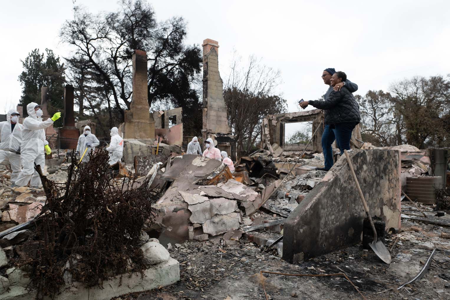 The Fords watch as Samaritan's Purse volunteers search for valuables amidst the destruction at their Altadena home.